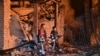 Ukrainian emergency workers amid the rubble at an energy infrastructure facility following a drone attack in Kharkiv on October 7, 2025.