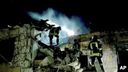 Пожарные на руинах разрушенного атакой российского беспилотника здания в Одессе, 23 апреля 2024 года