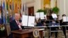 Прэзыдэнт Дональд Трамп трымае падпісаны выканаўчы ўказ, а маладыя людзі трымаюць копіі ўказу, падпісанага ім у Белым доме. Вашынгтон, 20 сакавіка 2025 году